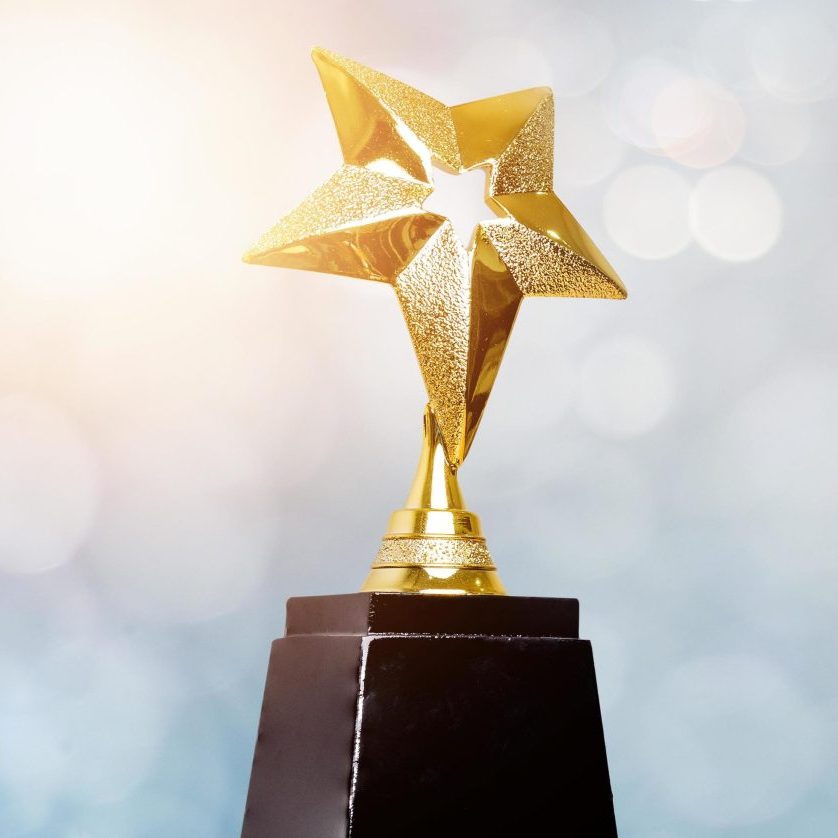 golden-trophy-award-bokeh-soft-blue-background-copy-space-for-text-winner-or-1st-place-gold-trophy-award-concept-free-photo